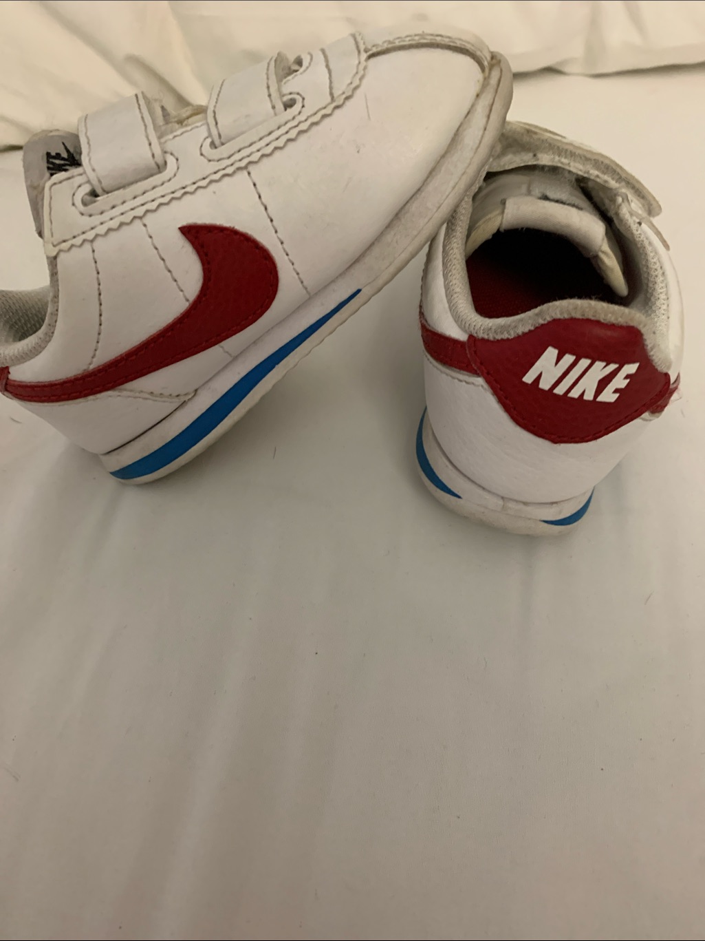 Nike Kids White Sneakers With Red Swoosh And Blue Accent